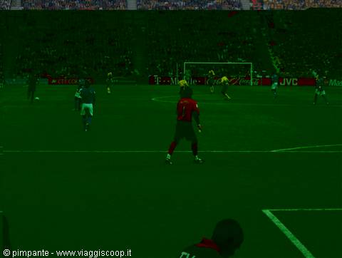 Football match at San Siro stadium, players on the floodlit pitch