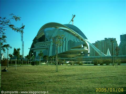 Palau de les Arts in Valencia under construction among cranes, lawn and palms