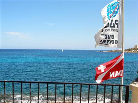 PADI and DAN dive flags flutter in front of the blue Mediterranean sea