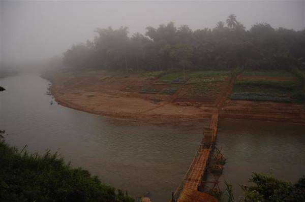 Bamboo bridge crossing the misty river at dawn, Luang Prabang