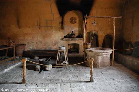 cave dwelling interior with ancient stone press and fireplace