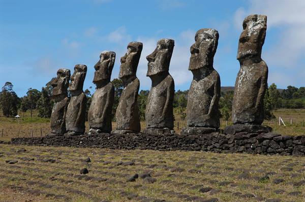 Seven volcanic stone moai on an ahu at Ahu Akivi, daylight