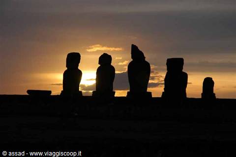 Moai statues of Rapa Nui silhouetted against the orange dawn sky