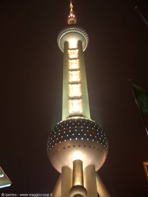 Oriental Pearl Tower lit up at night in Shanghai, seen from below