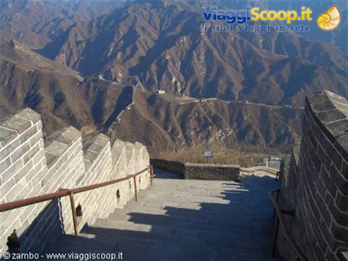Stone staircase with crenellations along the Great Wall over barren mountains