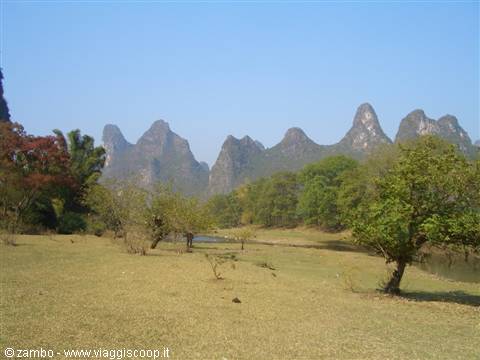 Yellow meadow and river before Guilin's karst peaks