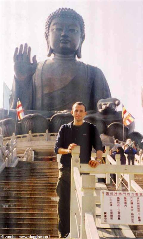 Tourist leaning on the railing in front of the Big Buddha at Ngong Ping