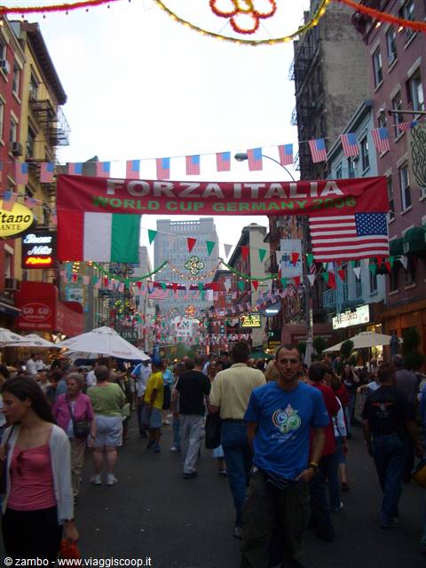 Crowded street in Little Italy with Forza Italy banner and flags