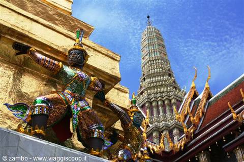 Yaksha demon statue in front of the golden prang at Wat Phra Kaew