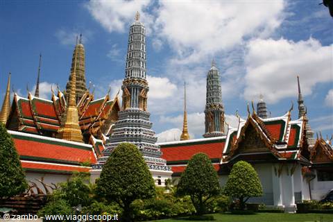 Mosaic-decorated prangs at Wat Phra Kaew temple in Bangkok under clouds