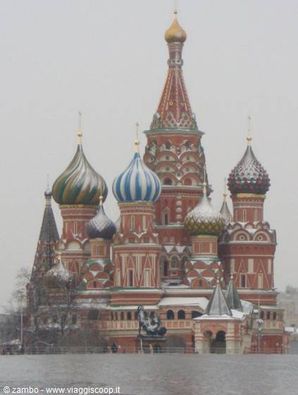 St Basil's Cathedral in Moscow, colorful snow-dusted domes under grey sky