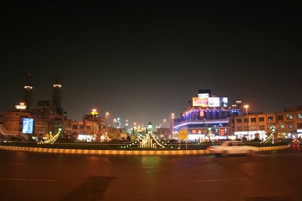Illuminated roundabout at night with city traffic, Tehran