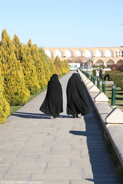 Two women in chadors walk through Naqsh-e Jahan garden, Esfahan