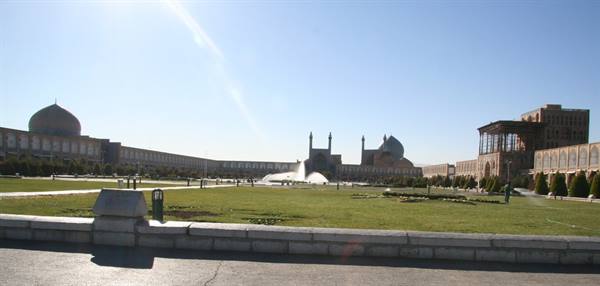 Naqsh-e Jahan Square in Esfahan, green lawn and fountains under bright sun
