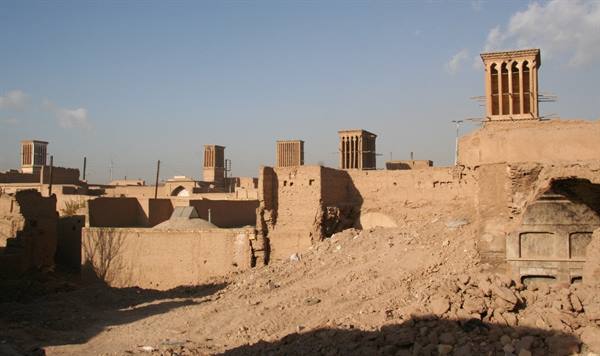 Mud-brick windcatchers rising above Yazd rooftops