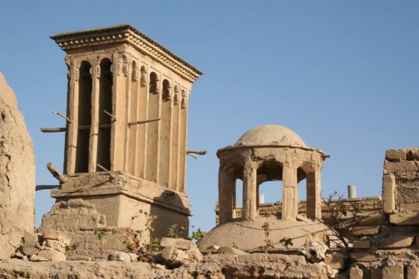 Mud-brick windcatcher tower and open dome, ruins in Yazd