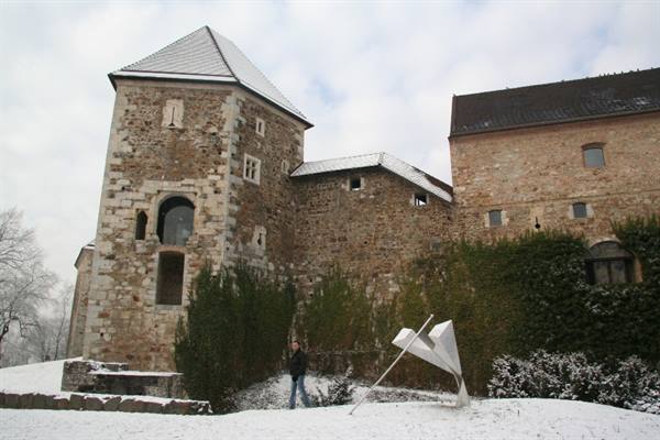 Ljubljana Castle, snow-dusted stone walls with white sculpture