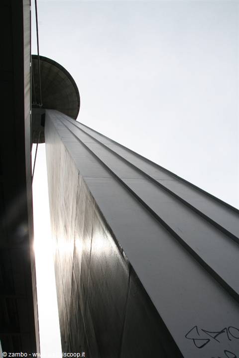 Concrete column against the sky, sunlight filtering from below