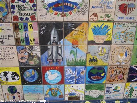 Hand-painted tiles with rocket, dove and colorful peace messages