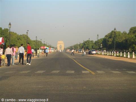 Tourists cross the wide avenue toward India Gate in New Delhi