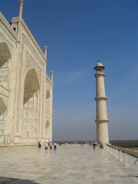 Tourists on the marble terrace of the Taj Mahal beside the minaret