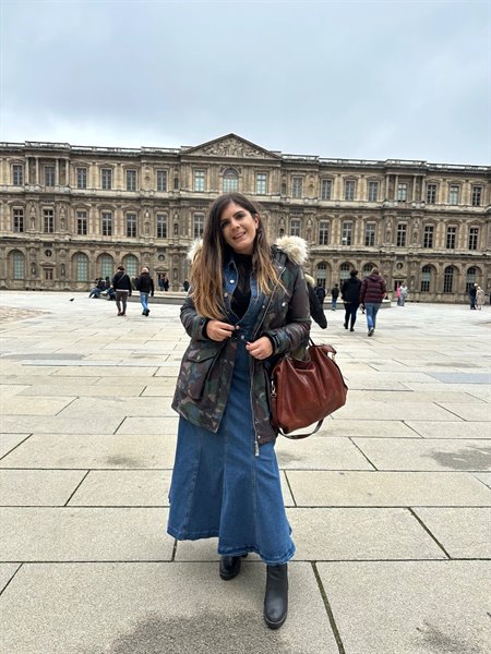 Smiling in front of the Louvre, a Parisian day to remember.