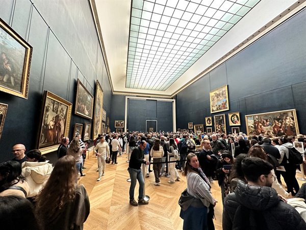 Under the Louvre light, queuing with the world to admire the Mona Lisa.