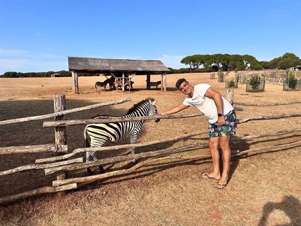 A caress to a zebra, what a thrill to meet it up close!