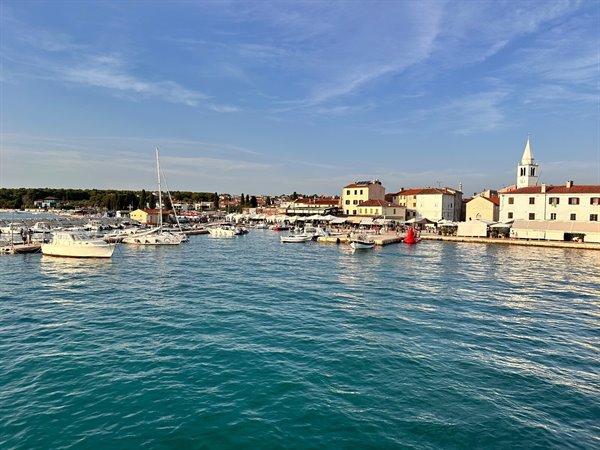 The port of Fažana at sunset, turquoise water and waiting for the boat.