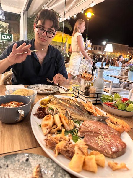 A fish dinner under the evening lights, a giant dish to share
