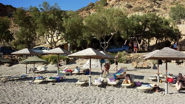 Lazy afternoons in the sun under the umbrellas of a Greek beach