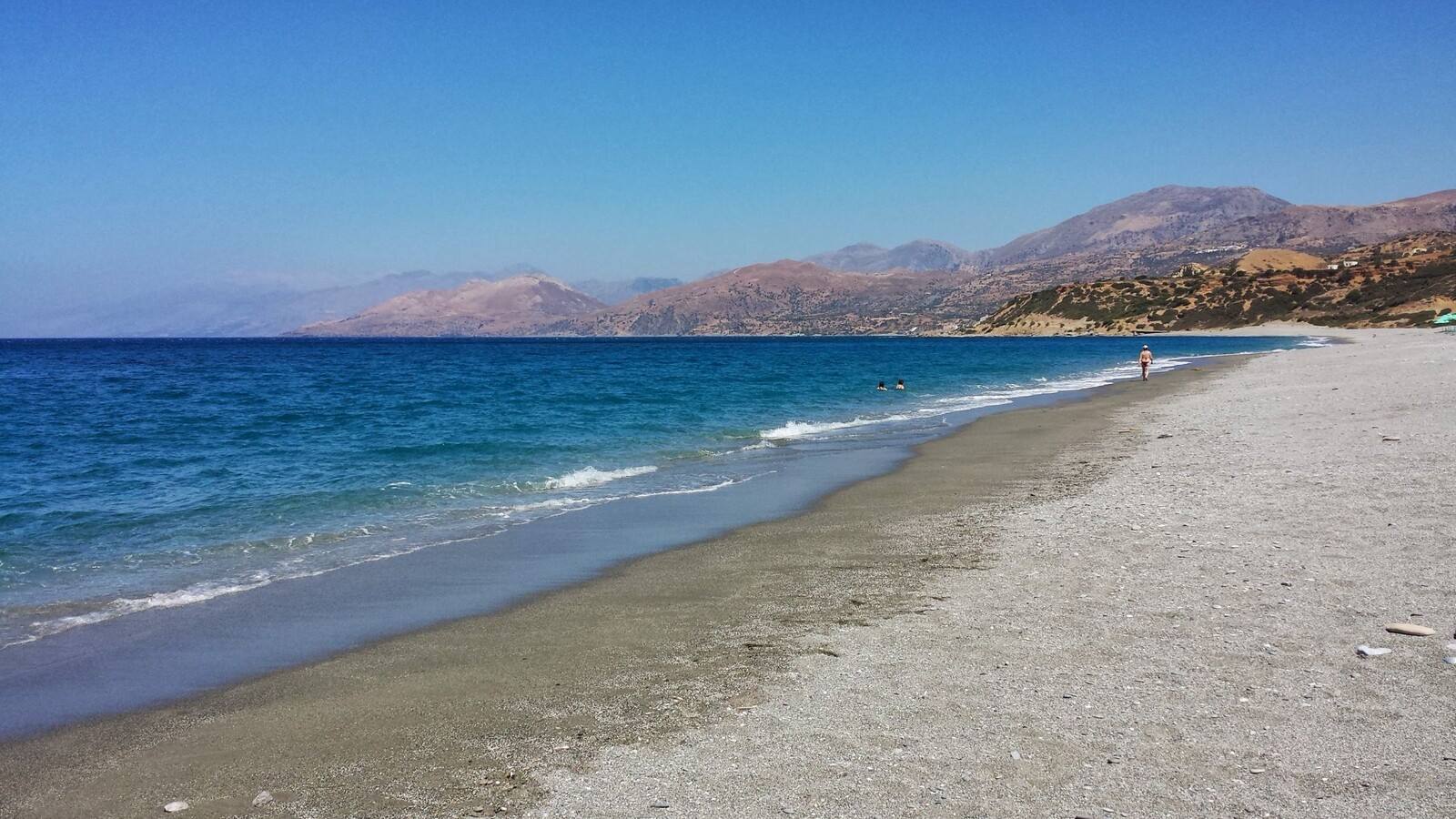 A long walk on the beach under the sun of Crete.
