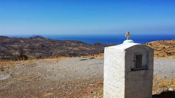 A stop along the Cretan road: a little white shrine and the sea on the horizon.