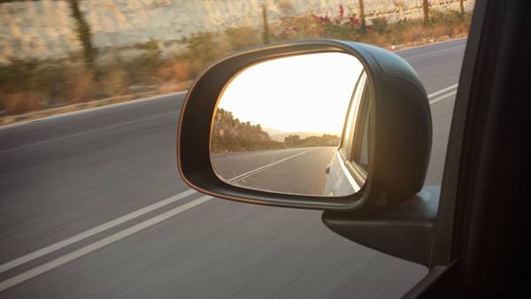 The sunset follows us in the mirror as we leave the coast behind.