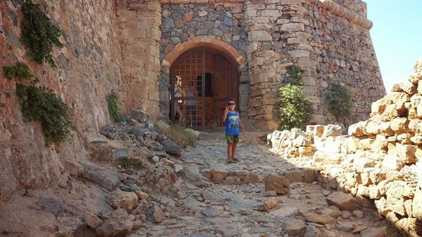 Exploring the ancient fortress of Spinalonga, a smile full of wonder.