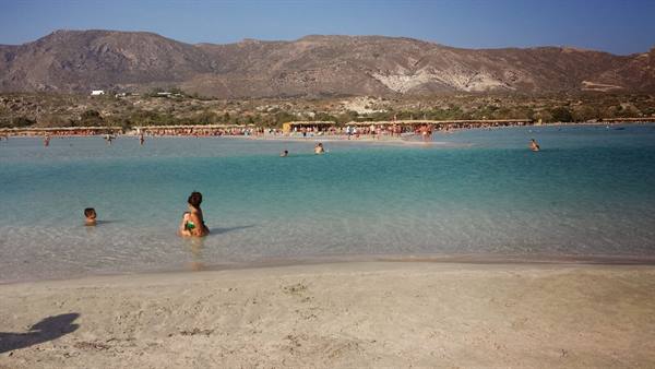A sunny day and games in the turquoise water at Elafonissi, Crete.
