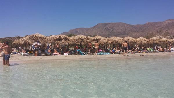 Under the thatched umbrellas of Elafonissi, a dip in the turquoise water of Crete