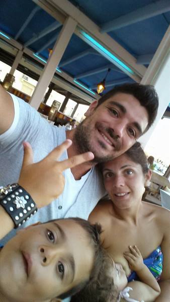 A family selfie full of smiles at the beach kiosk.