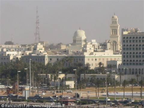 Tripoli skyline: white dome, minaret and buildings among palm trees