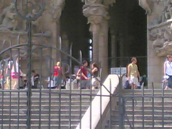 Tourists descend steps in front of the Sagrada Família facade, Barcelona