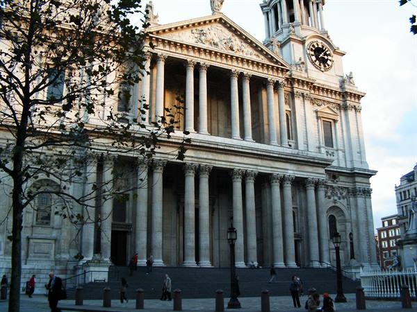 West front of St Paul's Cathedral, pale stone columns and passersby