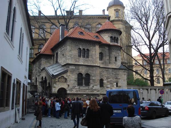 Tourists queueing outside the stone Klausen Synagogue, Prague