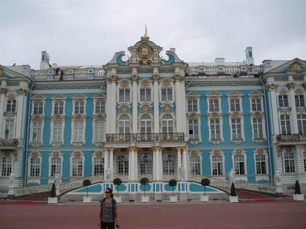 Tourist in front of the blue and gilded Catherine Palace facade at Tsarskoye Selo