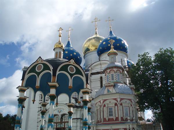 Blue and golden domes of the Trinity Lavra in Sergiev Posad under clouds