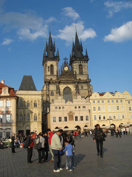 Tourists in the old square in front of Prague's Gothic Týn Church