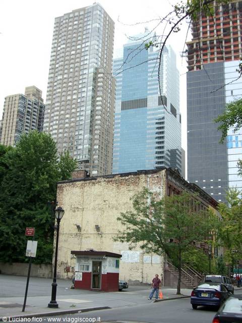 Manhattan skyscrapers towering over an old brick building in New York