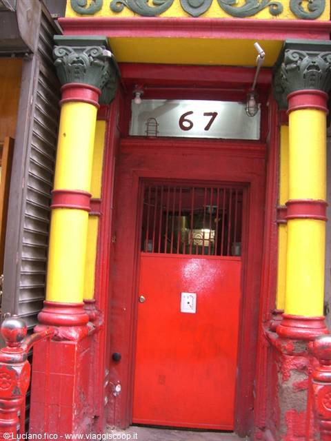 Entrance with red door and yellow columns, number 67