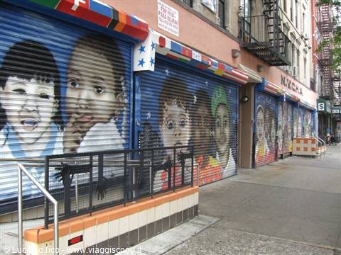Shop shutters painted with colorful murals of children, New York