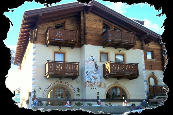 Wooden Hotel Ciarnì Rin da Rìn with balconies, snowy surroundings
