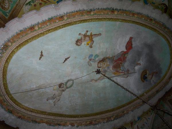 Fresco of cherubs and angel on oval church ceiling, natural light